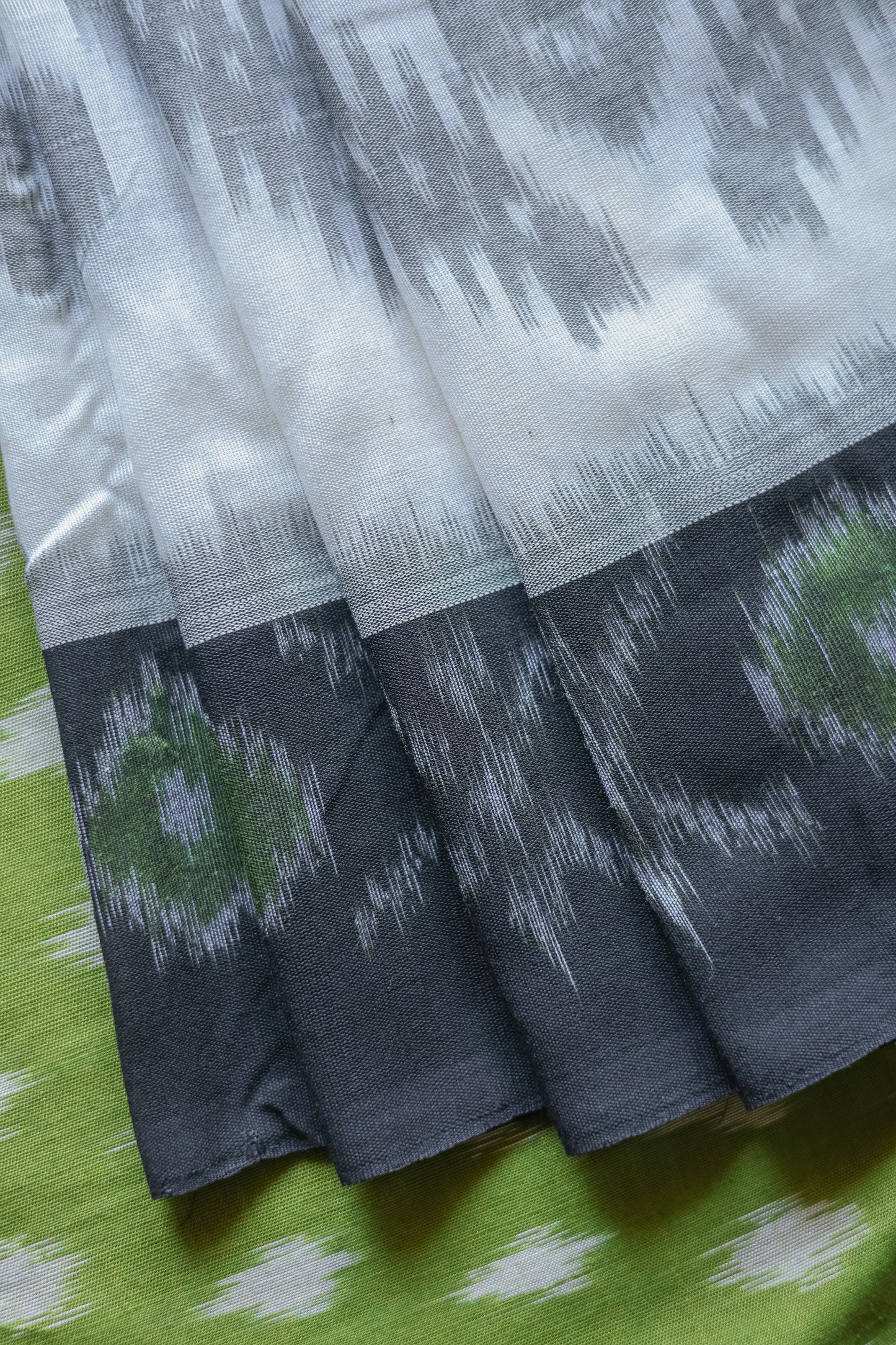 Off White and Green Ikat Cotton with Black Border Saree